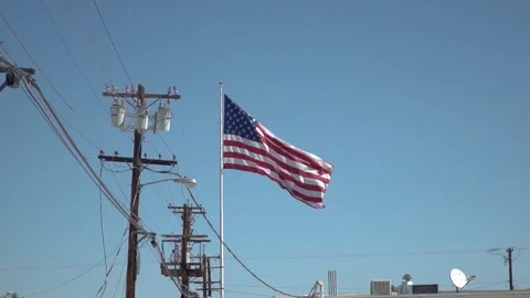 View of American flag on blue building background Stock Footage 254545141