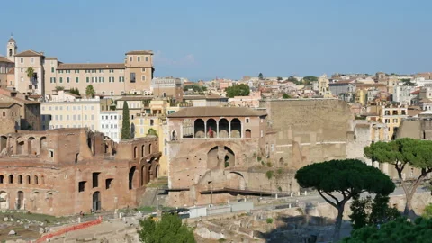 View on ancient buildings, green pine trees and Colosseum at the sunset in Rome Stock Footage 167208856