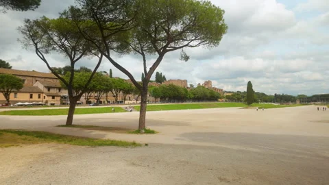 View of the ancient Circus Maximus with trees and ruins in the background under Stock Footage 312848139