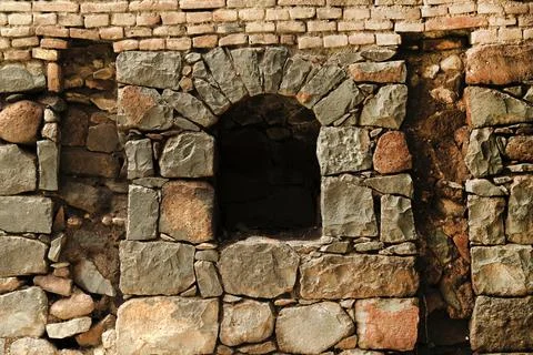 View from the ancient stone window, Medieval stone arch. Stock Photos