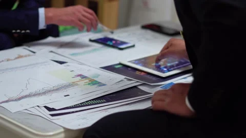 View and analyze trading stock market data on mobile tablet Stock Footage 163648342
