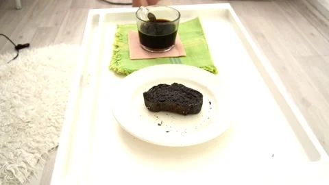 View and scene for breakfast with a black slice of bread and a glass Stock-Footage 129715092