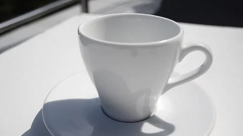 View and scene on a white ceramic glass in which a stream of drink, tea Stock-Footage 129715080