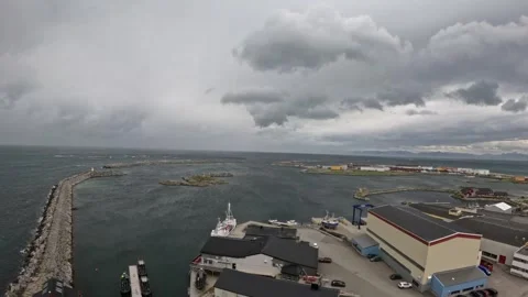 View of Andenes harbor, long breakwater pier, fishing ships, and ocean in Norway Stock-Footage 342755600