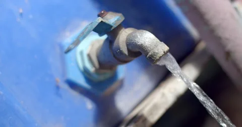 View angle oblique. Old blue faucet open that attached to the bucket of blue. Stock Footage 247839249