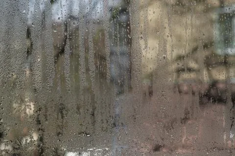 View from the apartment through the wet window you can see the house opposite Stock Photos