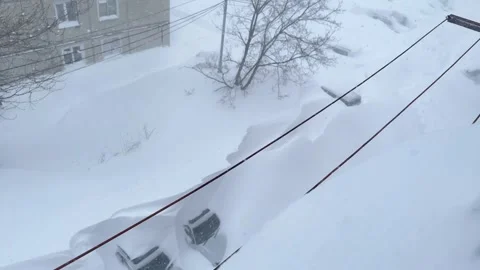View from the apartment window to the courtyard during a snowstorm. Cars covered Stock Footage 263006534