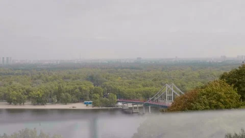 View apocalyptic city cloudy sky fog forest river trees foot bridge Stock Footage 135297089
