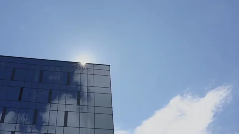 View of appearing from behind building sun disk against sky 스톡 동영상 134999091