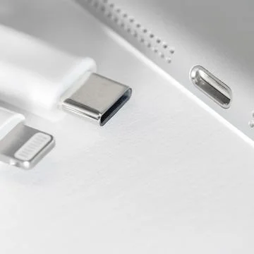 View of apple device with both usb-c and lightning cable charger. Eu forced.. Stock Photos