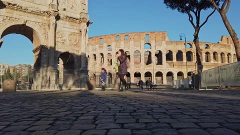 View of the Arch of Constantine and Coliseum with few tourists Stock Footage 145029435