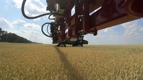 View from an arm of self propelled sprayer spraying water on wheat Stock Footage 138138764