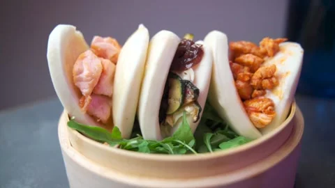 VIEW AROUND OF 3 DIFFERENT BAO bread Stock Footage 168263388