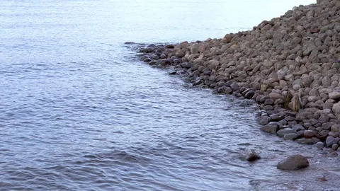 View of artificial quay with plenty of big stones with calm waters of the ocean Stock Footage 87316800