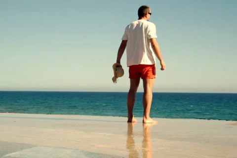 View from aside of young man raising his arms, slow motion Stock Footage 1068563