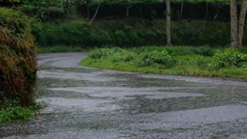 View of asphalt road in the mountains during rainy afternoon Stock Footage 319887941