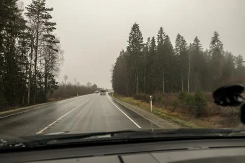 View of the asphalt road through the windshield of the car. Stock Photos