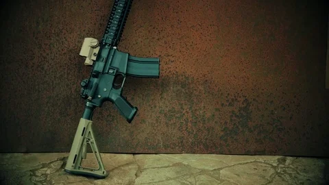 View of the assault rifle against the background of rusty steel Stock Footage 78019744