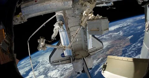 View of Astronaut Spacewalk Shuttle From Space Station Above Earth  Stock Footage 75783318