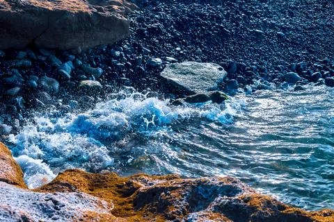 View of the Atlantic coast in Tenerife. Beach, volcanic stones, pebbles. Stock Photos