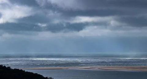 View of the Atlantic ocean with stormclouds and swirl patterns under a dra... Stock Photos