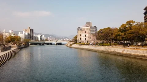 View of the Atomic Bomb Dome along the river in Hiroshima, Japan Stock Footage 124502801