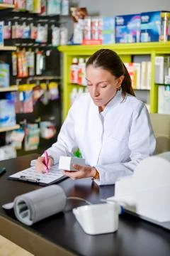 View of an attractive pharmacist at work Stock Photos
