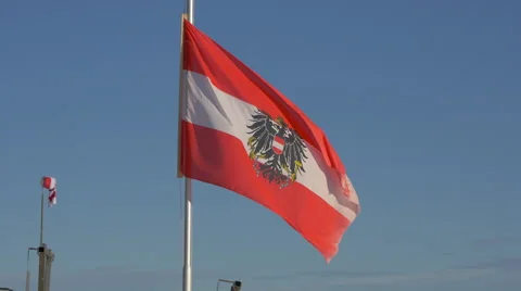 View of Austrian flag waving at Kitzbühel ski resort Stock Footage 61629578