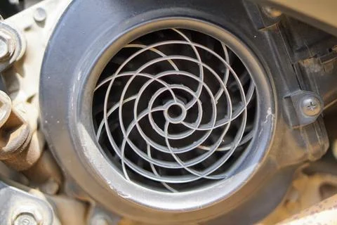 View of an automatic scooter engine cooling fan cover with a spiral pattern. Stock Photos