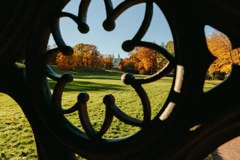 View of the autumn trees through the Gothic ornament of the ancient well, the Stock Photos