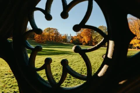 View of the autumn trees through the Gothic ornament of the ancient well, the Stock Photos