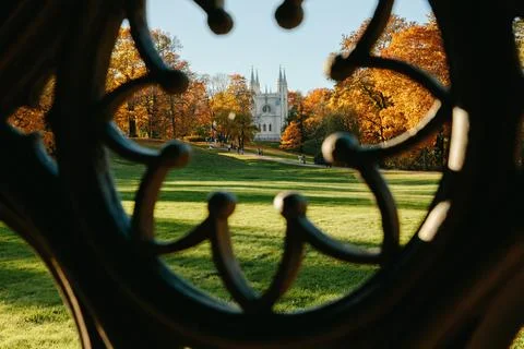 View of the autumn trees through the Gothic ornament of the ancient well, the Stock Photos
