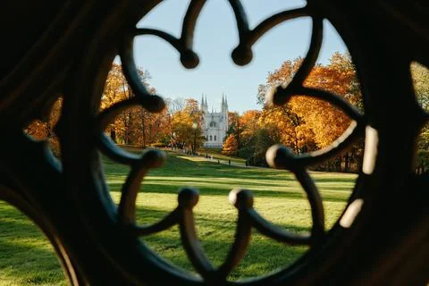 View of the autumn trees through the Gothic ornament of the ancient well, the Stock Photos
