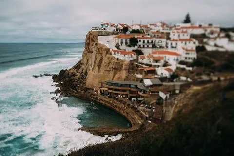 View to Azenhas do Mar rocky beach and village in Colares, Portugal. Tilt-s.. Stock Photos