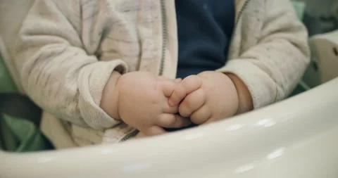 View of baby's hands moving in kid chair Video stock 147213867
