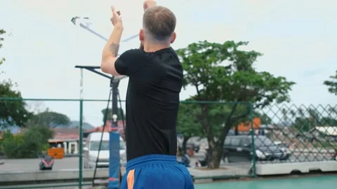View from the back of a basketball player throws the ball into the basket 動画素材 236981642