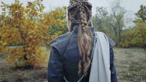 View from the back on a blonde lady walking in the forest, medieval ages, 4k Stock Footage 142800267