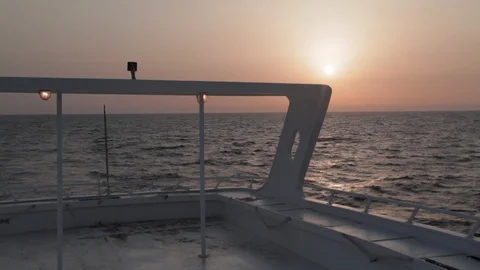 View off the back of a boat looking toward a setting sun Egypt Video stock 90925981