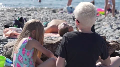 View from the back, the children of the blond brother and sister play in the Stock Footage 142370246