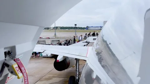 View from back door of passengers embarking at london gatwick Stock Footage 280706598