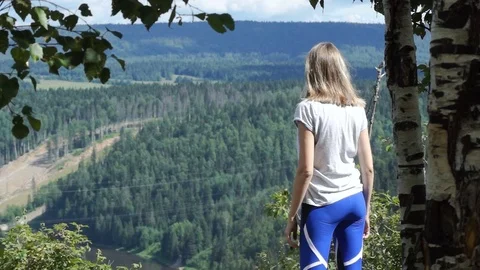 View from the back. the girl reached the top of the mountain Stock Footage 79324129