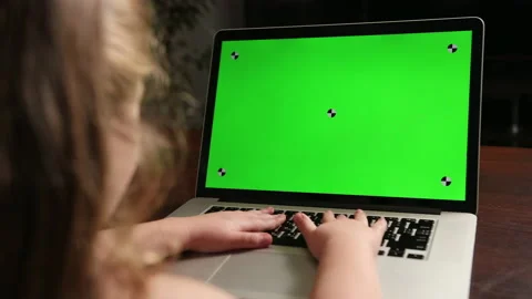 View from the back girl sitting at table and typing on laptop green chroma key Stock-Footage 150981409