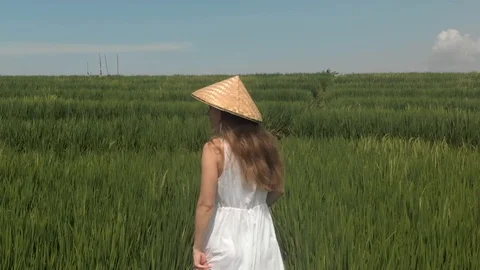 View from the back of good looking european young girl with long blond hair walk Stock Footage 129553679
