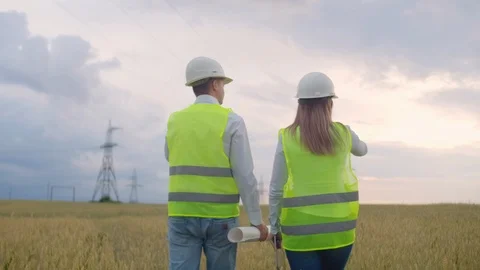 The view from the back: group of engineers at a high-voltage power plant with a Stock Footage 113408208