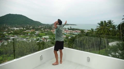 View from the back to a handsome young dark-haired Hispanic man in casual wear Stock Footage 213264298