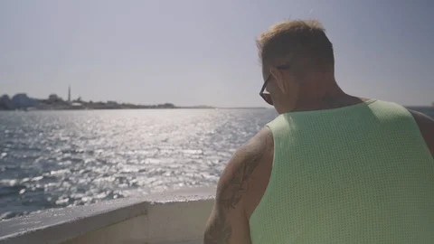 View from the back of a man standing on the stern of the ship. Stock Footage 94849820