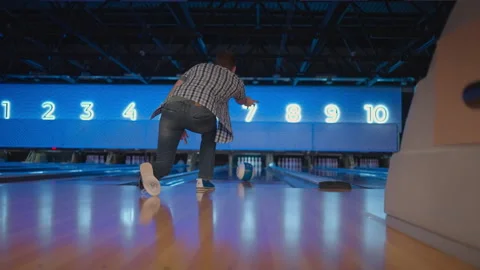 View from the back a man throws a ball and the camera follows him in a bowling Video stock 168231738
