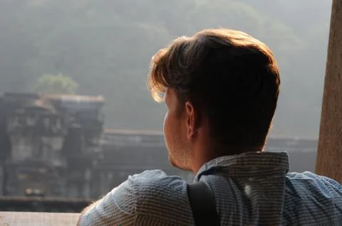 View from back of mans head, looking out at view of ancient ruins  Stock Photos
