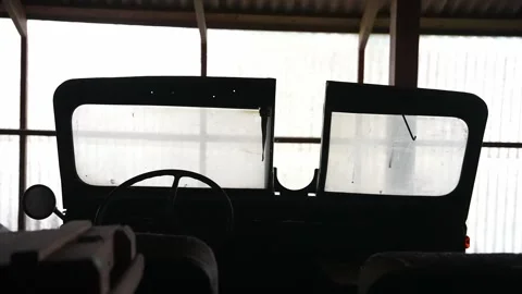View from the back of an old army jeep inside garage Stock Footage 294204834