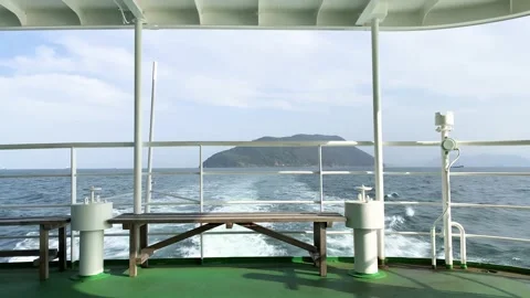 View from back of passenger ferry ship sailing in ocean with island landscape Video stock 154190166